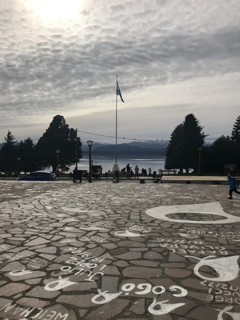 View of lake and Argentina flag from Centro Civico in Bariloche. Visiting Centro Civico is one of the top free things to do in Bariloche.