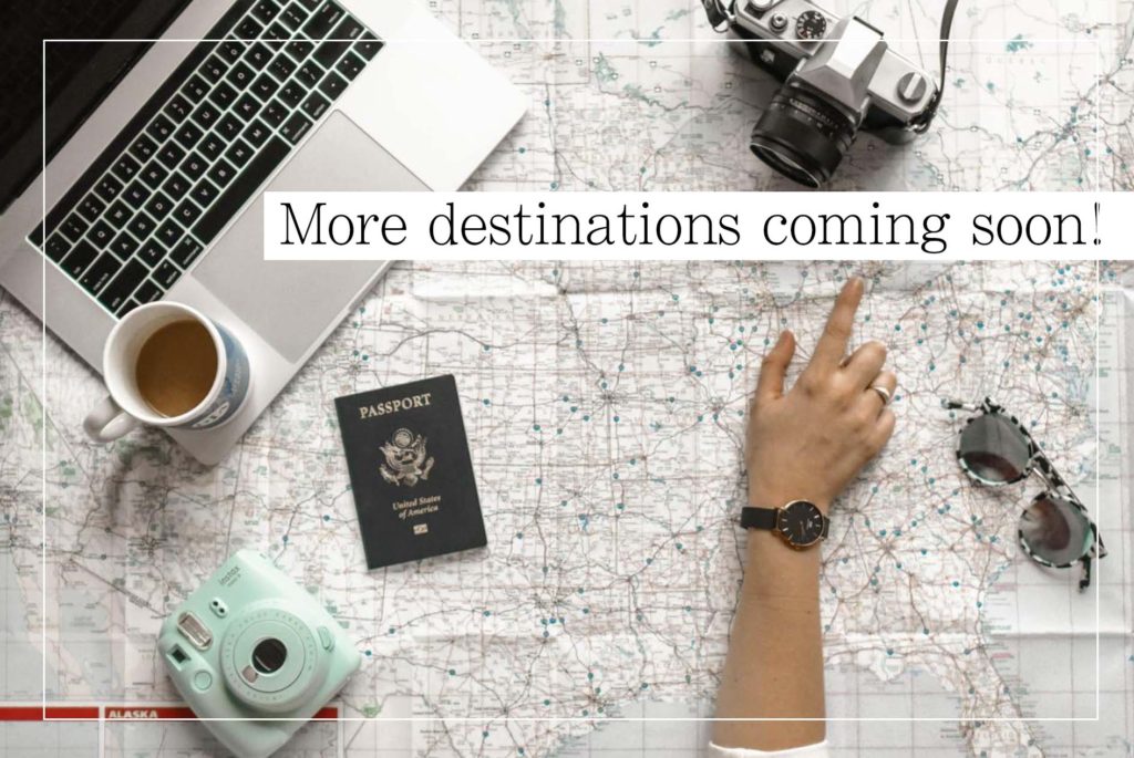 more destinations coming soon with finger pointing to a spot on the map and laptop
