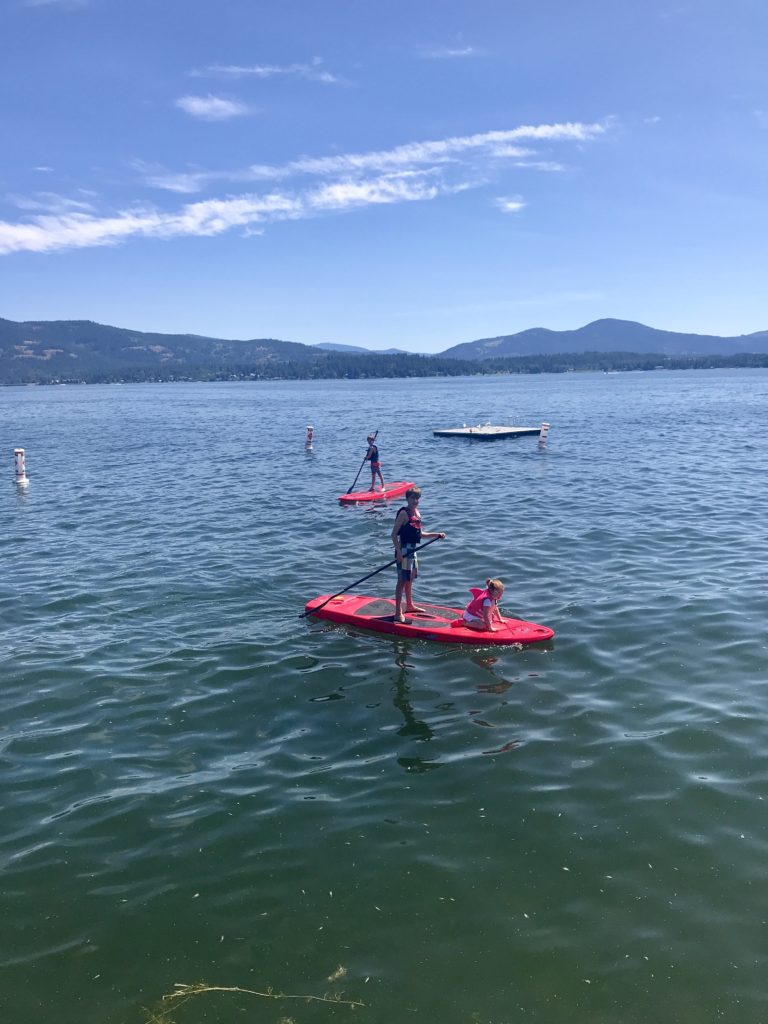 3 kids on paddle boards in lake ponderay