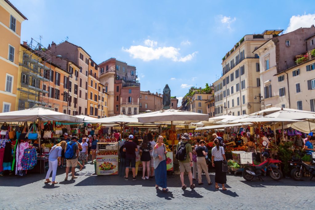 people visiting the outdoor market in the campo de fiori in Rome.