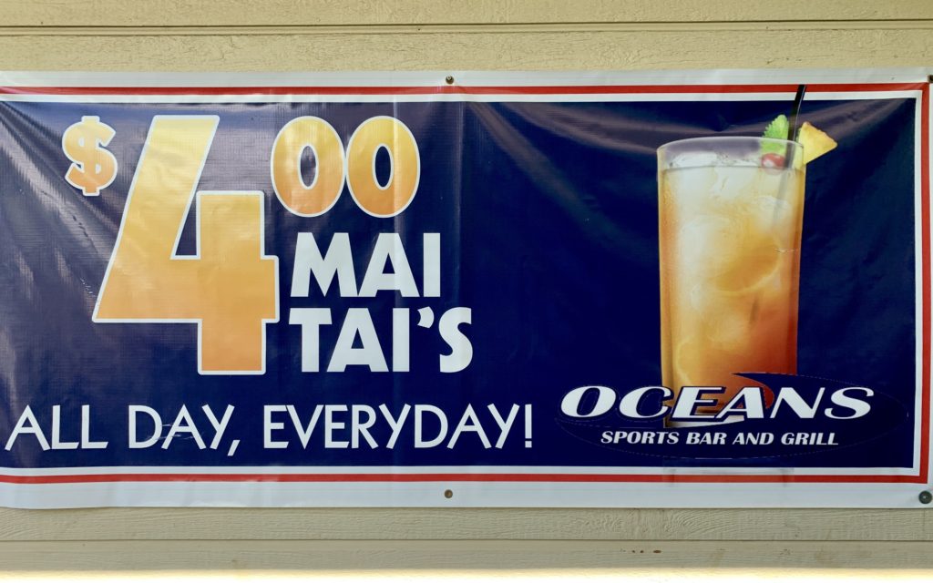 sign advertising $4 mai tai's at Ocean's Sports Bar & Grill for though visiting Kona on a budget