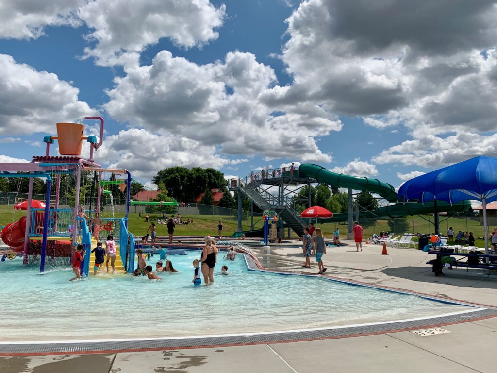 south spokane county aquatics center with kids water feature and green slide