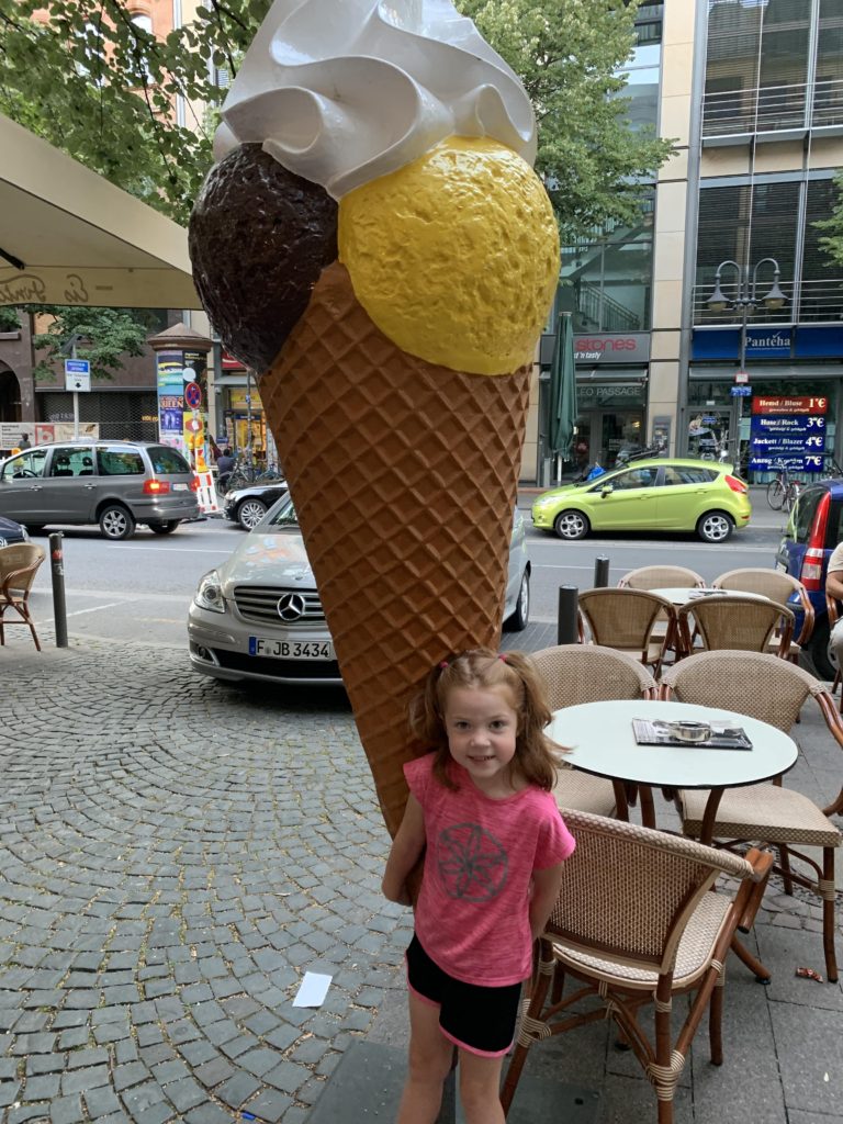 little girl in front of fake giant ice cream cone in Frankfurt