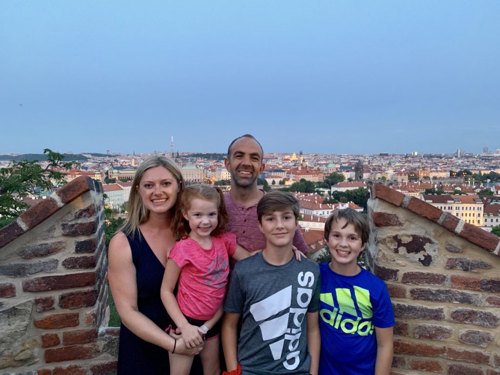 Family of 5 with city of Prague in the background