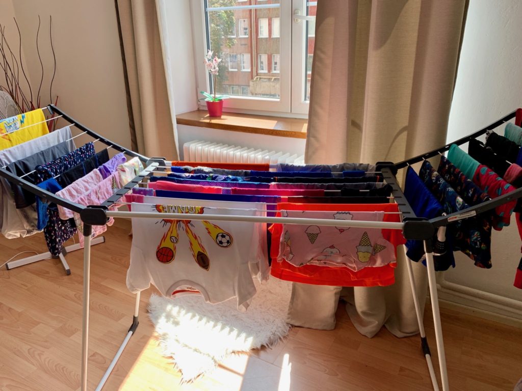 clothes drying on a rack in front of a window