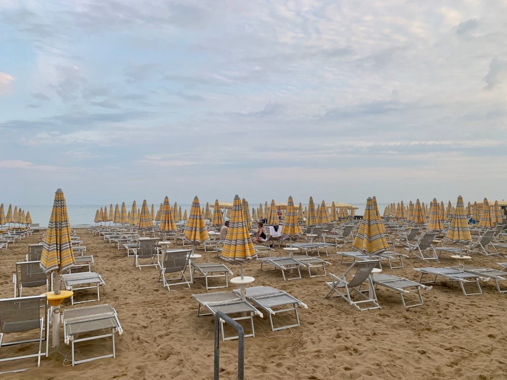 rows of sun beds and umbrellas on Lido di Jesol beach in Venice