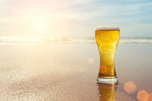 beer in glass on beach